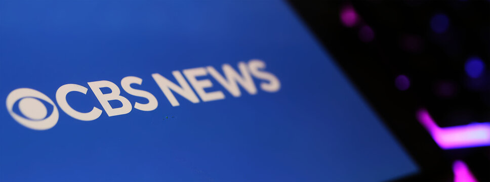 Viersen, Germany - March 1. 2024: Closeup of smartphone with logo lettering of CBS News on computer keyboard