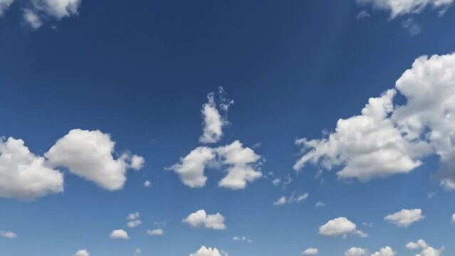 This calming footage shows fluffy white clouds drifting slowly across a clear blue sky. Perfect for use as a background or for creating a relaxing atmosphere.
