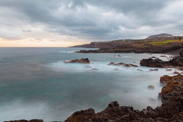 Stone coast with cliffs of the Atlantic Ocean at sunrise. Tenerife. Canary Islands, Spain