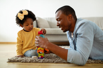 African american father spending time with his cute little daughter