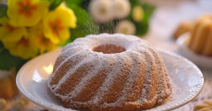 Sprinkling bundt cake, babka with powdered sugar, close up view. Traditional Easter bundt cake