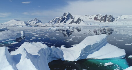 Close up melting iceberg on waters of Southern Ocean to ice-shelves, glaciers and mountains aerial....