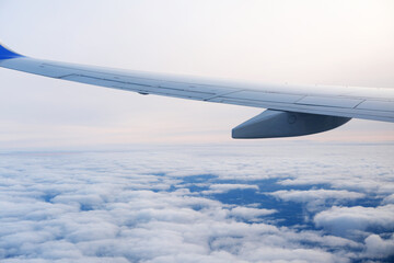 Serene Sky and Airplane Wing at High Altitude. Calm view of a clear sky with an airplane wing...