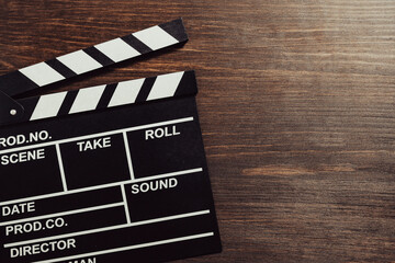 Vintage photo of movie clapper on wooden background, closeup, top view, copy space