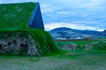 Moss-Covered Turf House During Blue Hour: Harmonious Icelandic Landscape