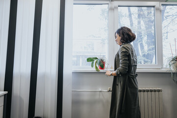 Elegant businesswoman smiling by the window in modern office.