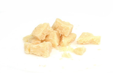 Pieces of parmesan cheese isolated on white background. Parmesan crumbs on white. 