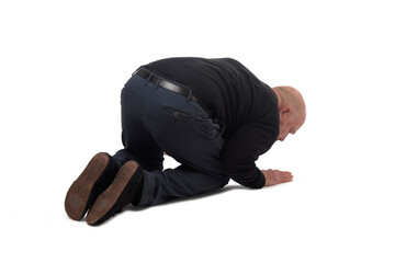 back side view of a man on his knees staring at the ground on white background