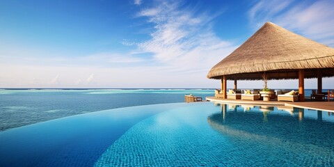 a broad view of an infinity pool with a thatched roof - obrazy, fototapety, plakaty