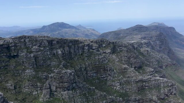 Pan of view from Table Mountain over  mountains and ocean - elevated view from look out point