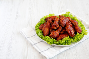 Homemade Honey BBQ Chicken Wings on a Plate, side view. Space for text.