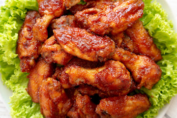 Homemade Honey BBQ Chicken Wings on a Plate, top view. Flat lay, overhead, from above. Close-up.