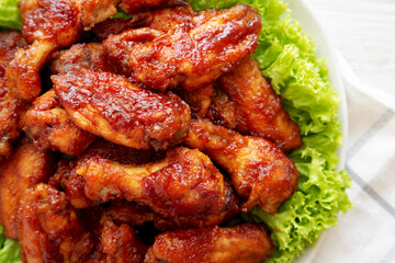 Homemade Honey BBQ Chicken Wings on a Plate, top view. Flat lay, overhead, from above. Close-up.