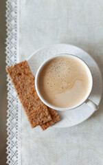 A cup of delicious morning coffee with slices of fitness of bread. Selective soft focus - 755176228