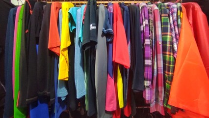 Kinds of clothes displayed in the rack to make the customers easier to choose the clothes 