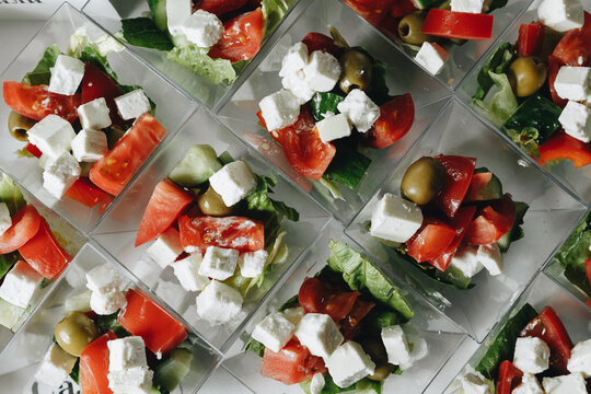 Beautifully decorated catering banquet table with different food snacks and appetizers with sandwich, caviar, fresh fruits on corporate christmas birthday party event or wedding celebration.