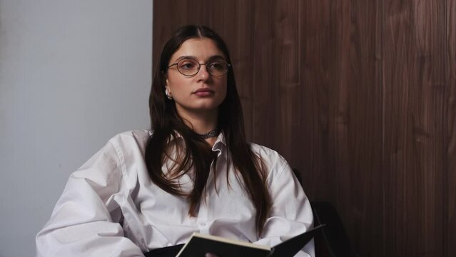 Close Up of Caucasian shocked Therapist psychologist Talking Sitting in a Modern Industrial Office Space, Writing Down Notes and Filling Out the Form shoking news. Mental Health Concept.