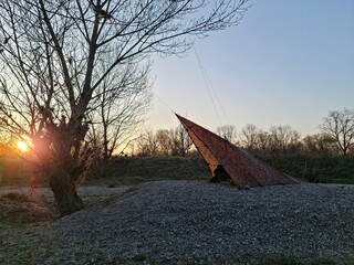 sunset in the park with tarp shelter