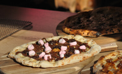 Pizza cooked in a wood-fired oven with gummies