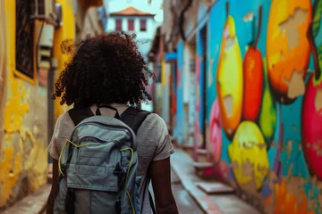 Papier Peint photo Lavable Ruelle étroite A man wearing a yellow tshirt is strolling down a city alleyway with his travel backpack, enjoying the art and leisure of the narrow road