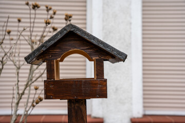 Wooden bird feeder. Bird feeder close up.