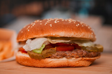classic American meal: a mouthwatering burgerwith no cheese and crispy fries served in a bustling restaurant setting