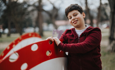 A young boy enjoys outdoor activities in a park, exhibiting joy and youthful energy while playing...