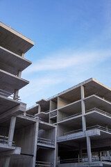 Close up of grey block empty new building at Construction process towards blue sky. Tallinn,...