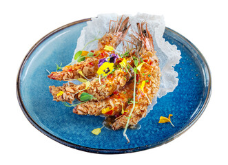 Exotic sea dish tiger squid shrimp fried in peanuts in a plate decorated with flowers. On a white isolated background.