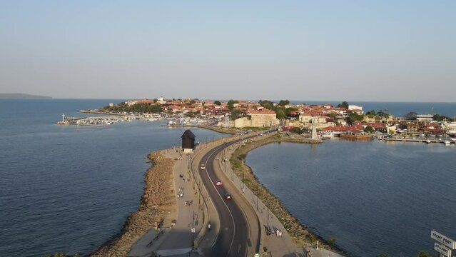 Bridge to Old Town of Nessebar, windmill and lanterns, road, landscape  Beautiful historical town Nessebar in Bulgaria. Drone view