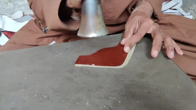 Craftsman Handcrafting an Upper Shoe Component in Workshop
