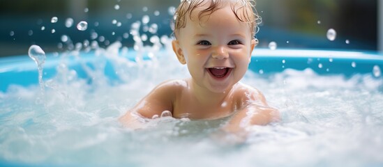 Fototapeta na wymiar A happy baby is joyfully splashing in a pool of water, smiling brightly while enjoying a hydrotherapy session in a jacuzzi spa designed for children. The baby is surrounded by water, displaying pure