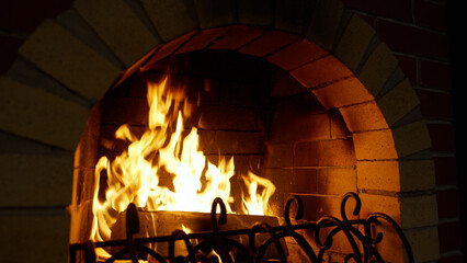 Fire, bonfire, burning wood in a stove-fireplace for heating a house. Wood-burning fireplace in the...