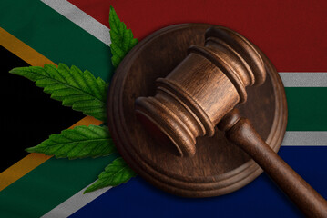 Judge's gavel and cannabis leaf on the flag of South Africa. Medical cannabis concept.