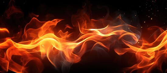 A close-up view of fiery flames dancing and flickering intensely on a stark black background. The vibrant orange and yellow colors of the fire create a striking contrast against the darkness.
