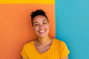 Happy hispanic lesbian young woman looking at the camera on a colorful background