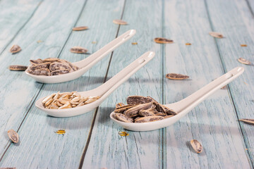 Sunflower seeds served as snacks in ceramic teaspoons.