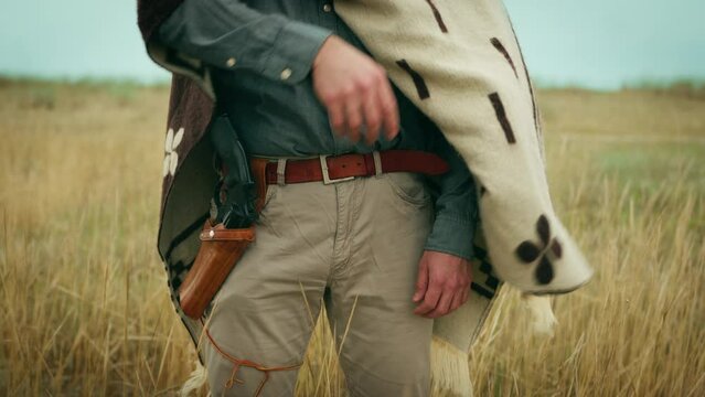 Cowboy ready to duel shows the gun