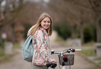 Smiling Girl Holds Bicycle In Spring With Blurred Park Background - 755228872