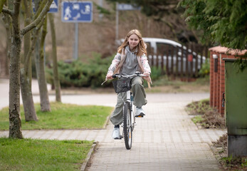 Girl Rides Bicycle Among Private Houses In Europe During Spring - 755229099