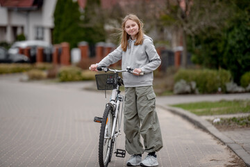 Girl Rides Bicycle Among Private Houses In Europe During Spring - 755229247