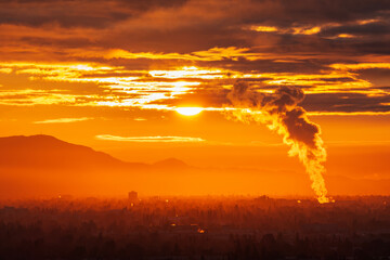 Industrial steam billowing into glowing sunrise above the San Fernando Valley in Los Angeles...