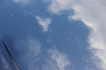 sky reflected in a car