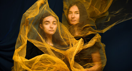 Dramatic portrait of two young veiled women - 755236273
