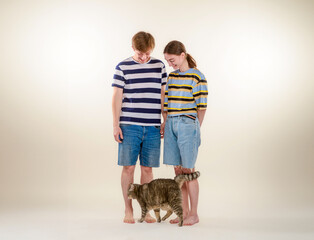 couple and cat on a light background in full growth - 755236297