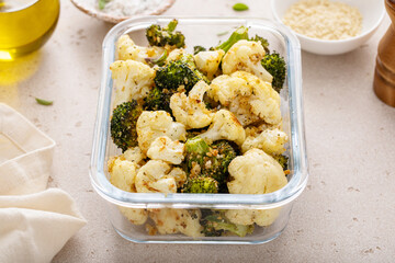 Roasted cauliflower and broccoli in a meal prep container, healthy vegetable side dish - 755237266