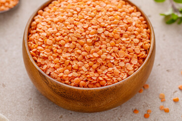 Red lentils raw in a bowl ready to be cooked - 755237459