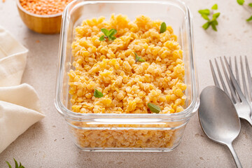 Cooked red lentils in a meal prep container, healthy vegan protein source - 755237838