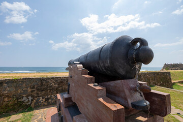 Fototapeta na wymiar Old colonial artillery cannons on bastion along the coast line of Galle, Southern Province of Sri Lanka