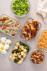 Healthy meal prep with cooked chicken breast, boiled eggs, roasted vegetables, cooked lentils, couscous salad and nuts - 755239831